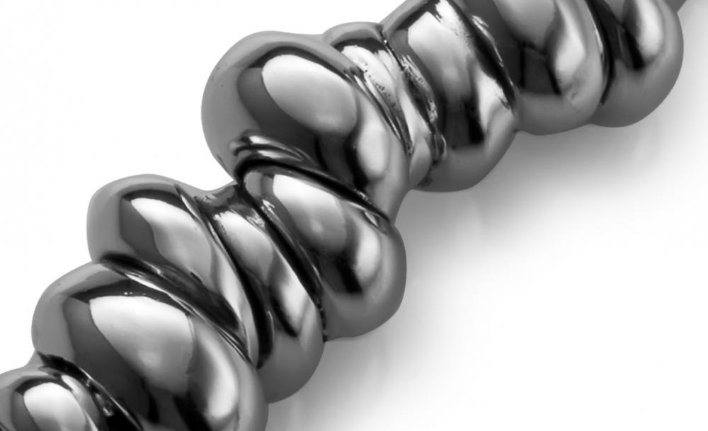 Close-up of a polished metallic twisted rod with a shiny surface.