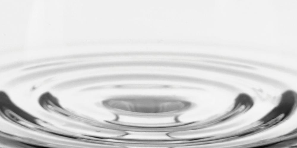 Close-up view of concentric circles on a clear glass surface.